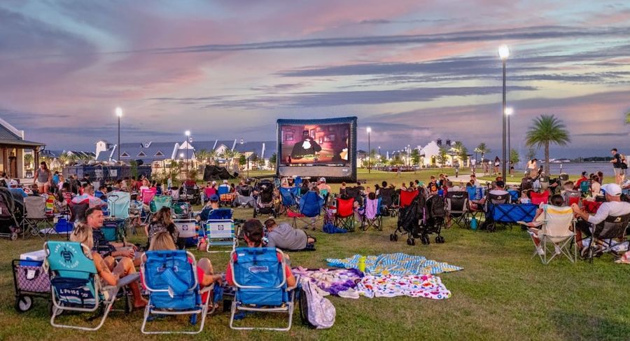 Outdoor movie audience seated on the lawn at Waterside Park